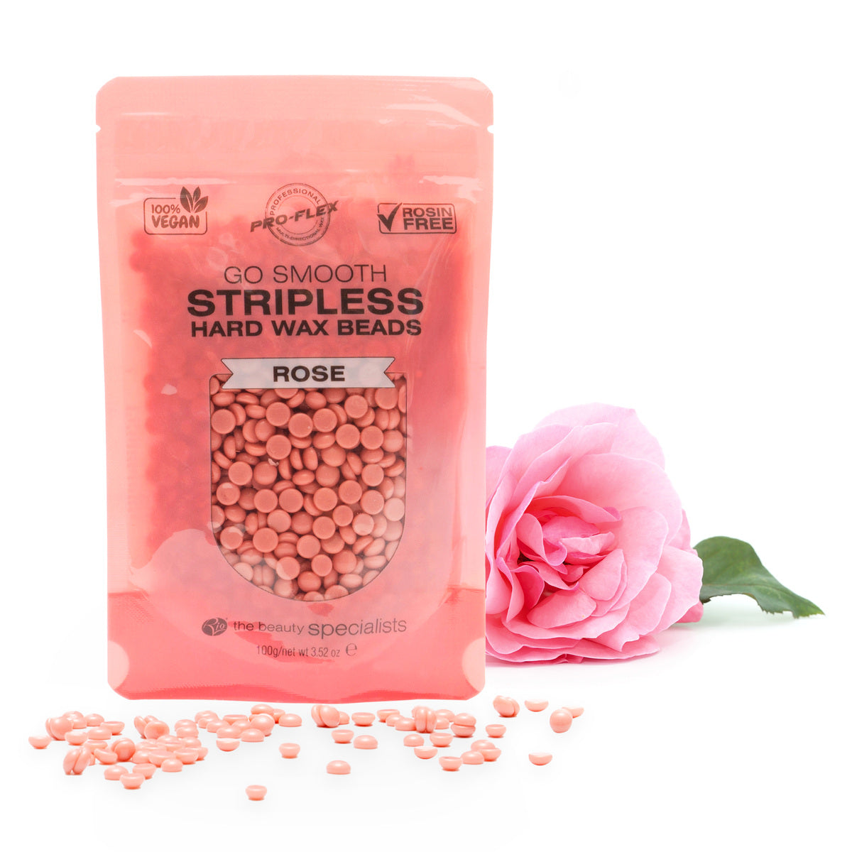1 pouch of 100g rose scented GO SMOOTH STRIPLESS hard wax beads with a pink rose laying in the background