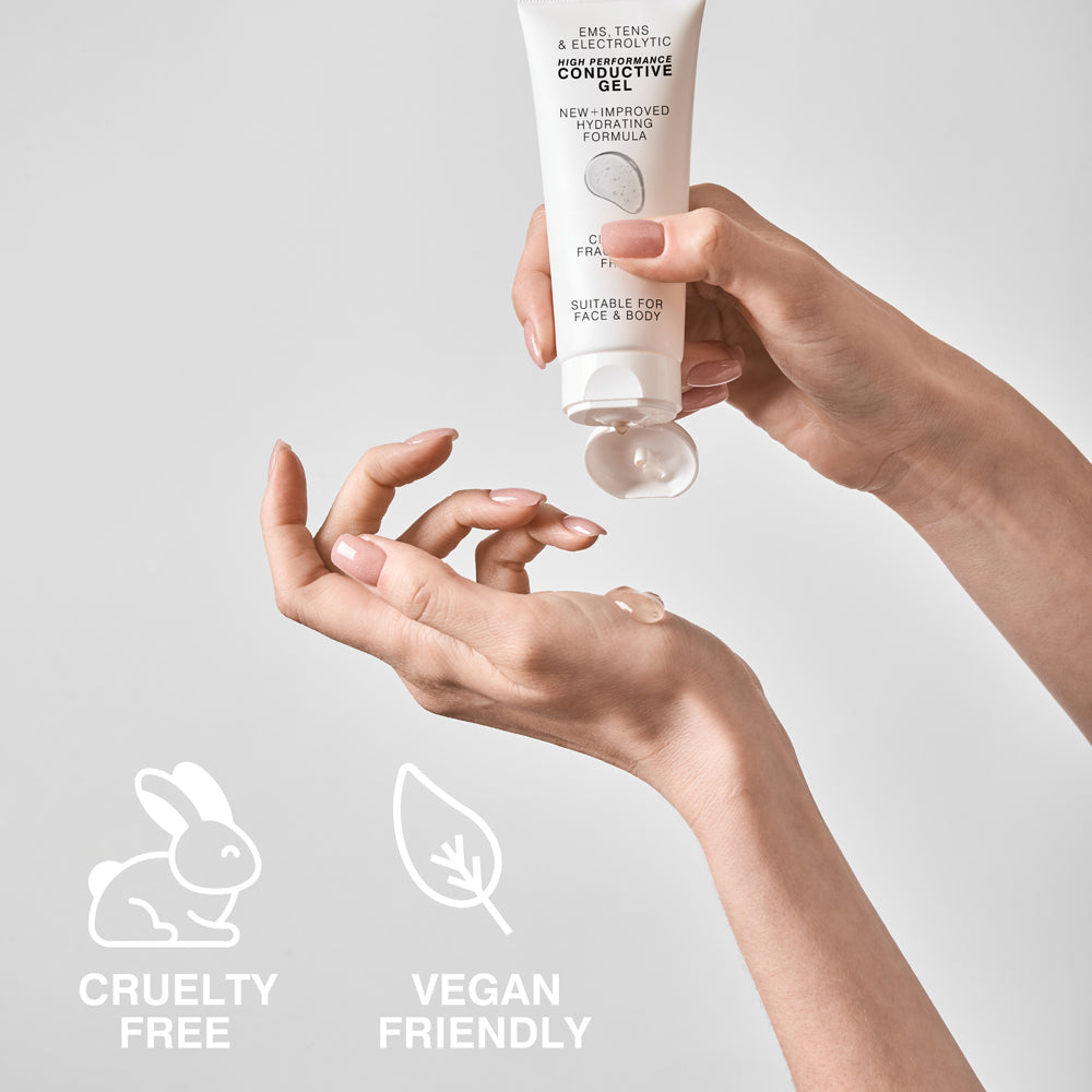 A person dispenses Rio EMS, TENS, Electrolytic and Micro-Current Toning Conductive Gel 85ml from a white tube onto their hand. The label notes its suitable for face and body, plus cruelty-free and vegan-friendly. Perfect for EMS or micro-current routines.