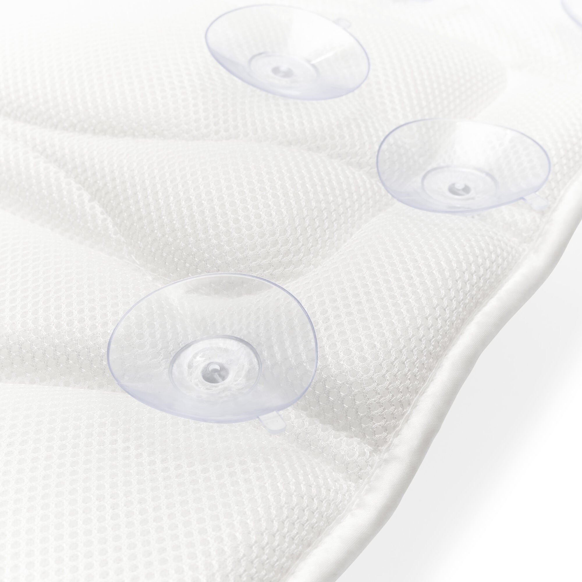 Close-up of the Rio Luxury Bath Mat & Pillow in white, featuring three clear suction cups for secure grip, shown on a white surface.