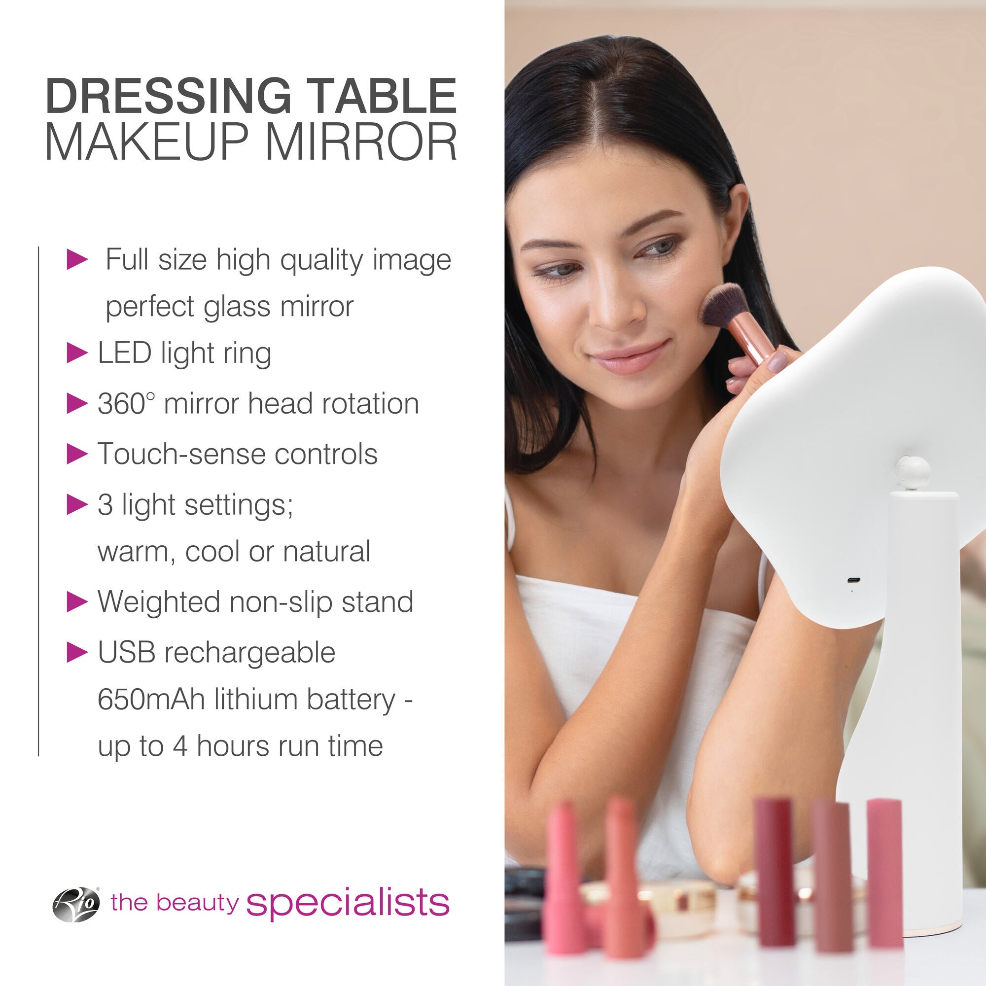 A woman uses the Rio Illuminated Full Size Beauty Mirror with touch-sense controls, 3 adjustable light settings, USB recharge, and 360° rotation, surrounded by makeup products.