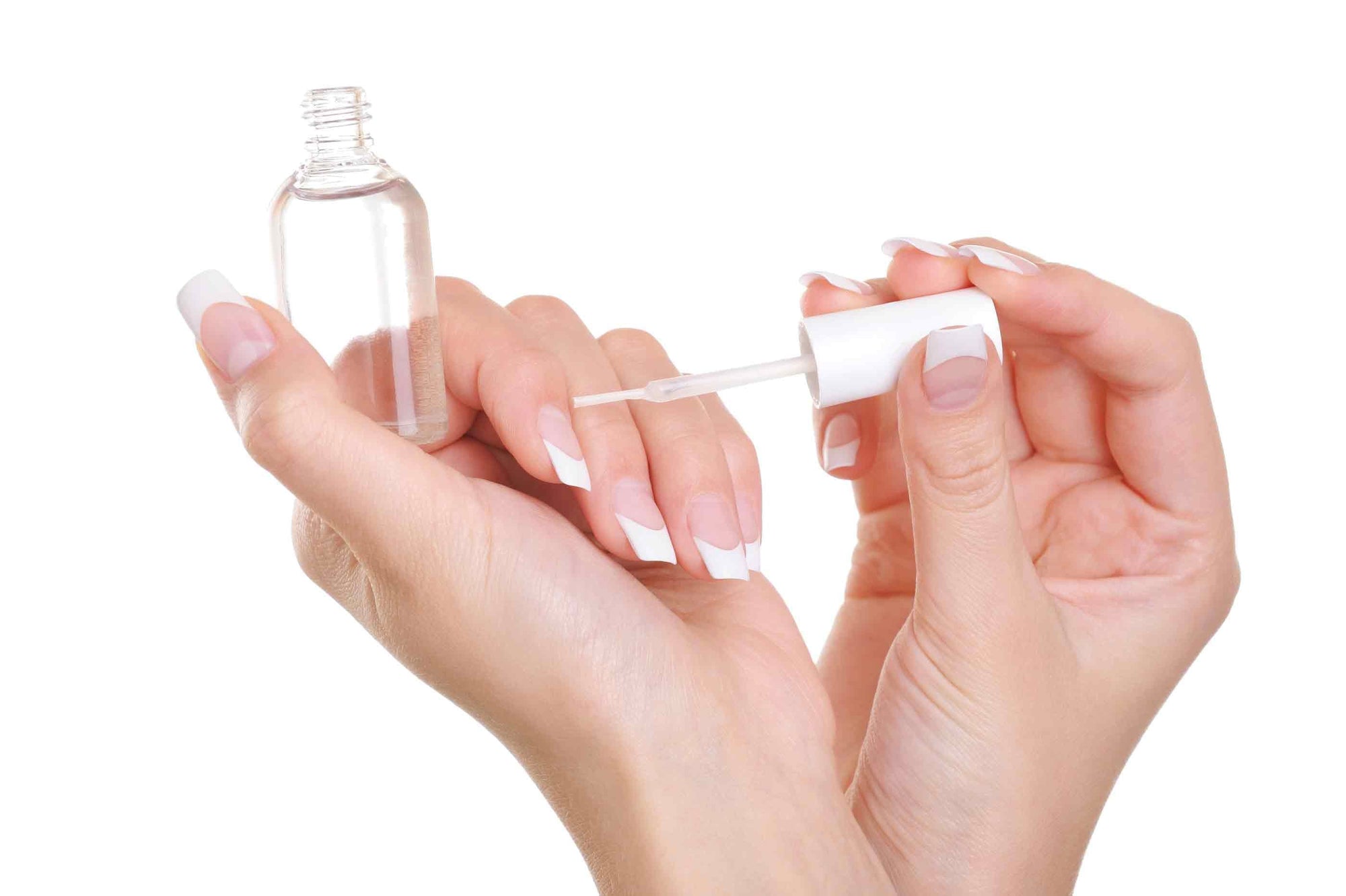 lady painting gloss onto french manicured nails 
