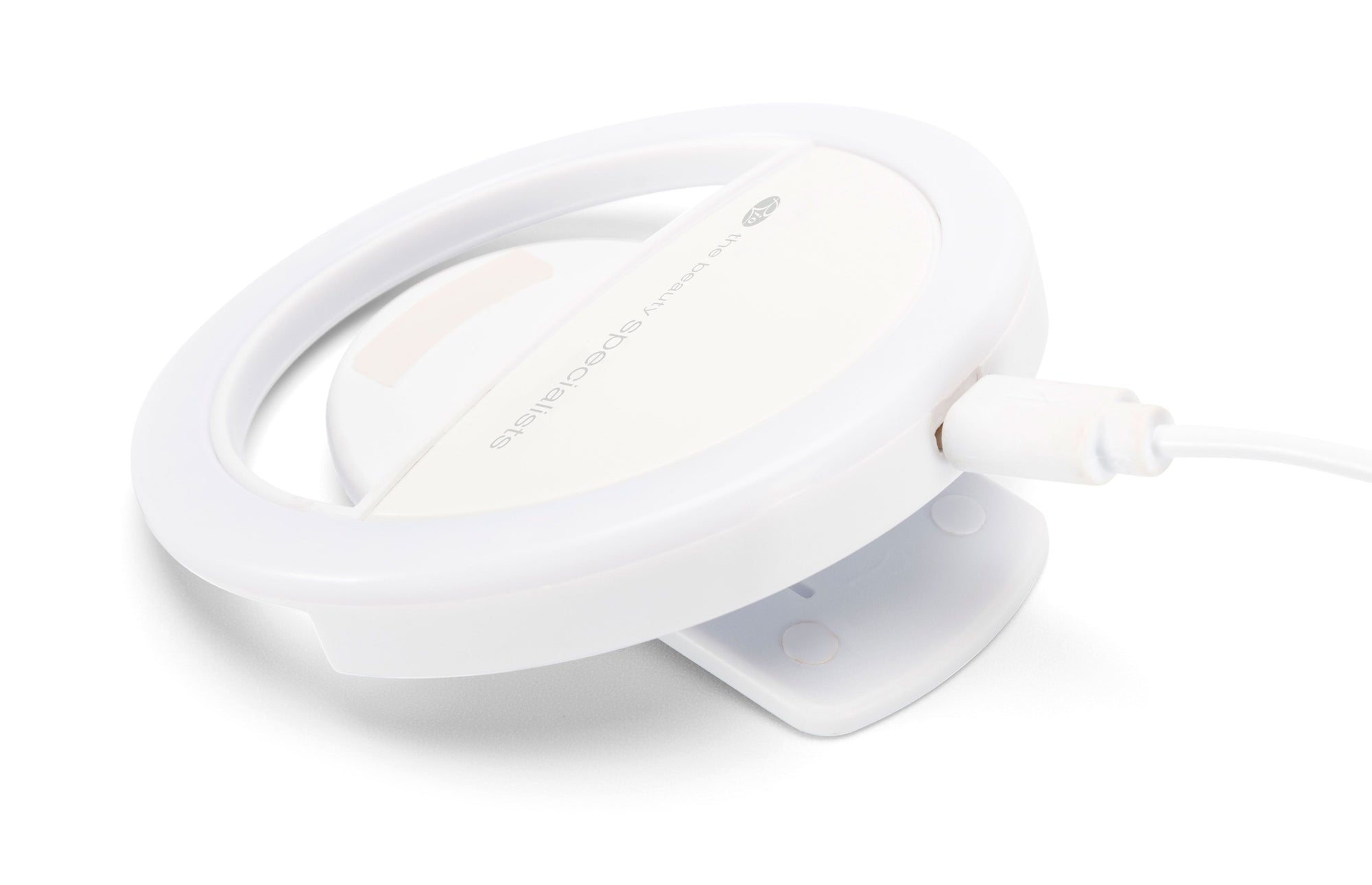 The Rio Beauty Glow Smartphone Ring Light, with a white circular design and clip-on base, connects via USB for power. Its compact, portable form is ideal for capturing perfect selfies anywhere.